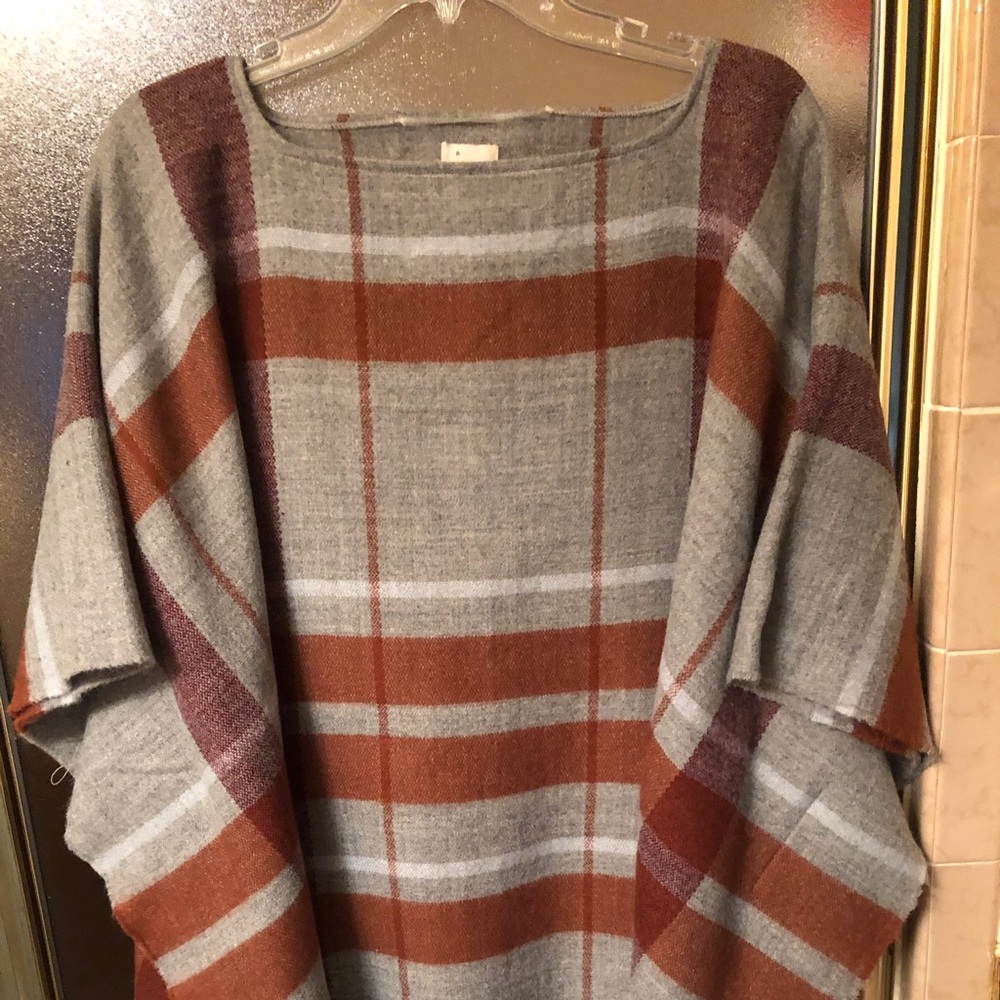 Cape/poncho in gray and rust plaid.